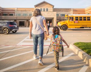 mom and daughter heading to school