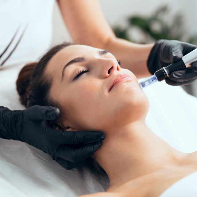 Woman on table receiving skin treatment.